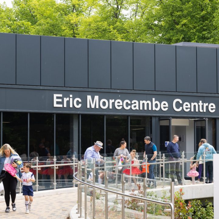 People walking in and out of a building labelled "Eric Morecambe Centre."