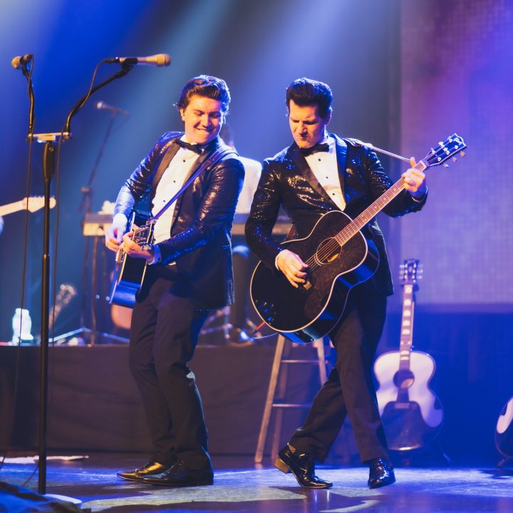 A dynamic music duo performance on stage.