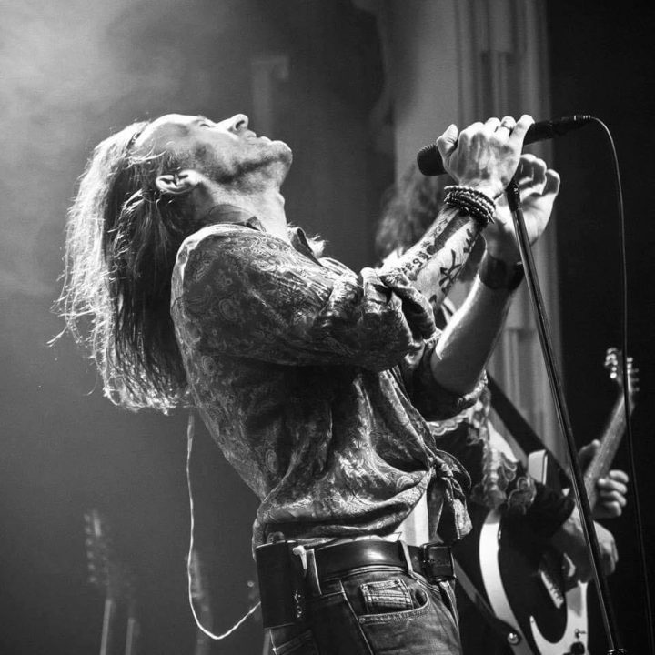 Black and white photo of a long-haired performer.
