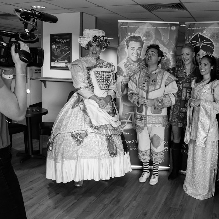 A camera operator films five people in costume.