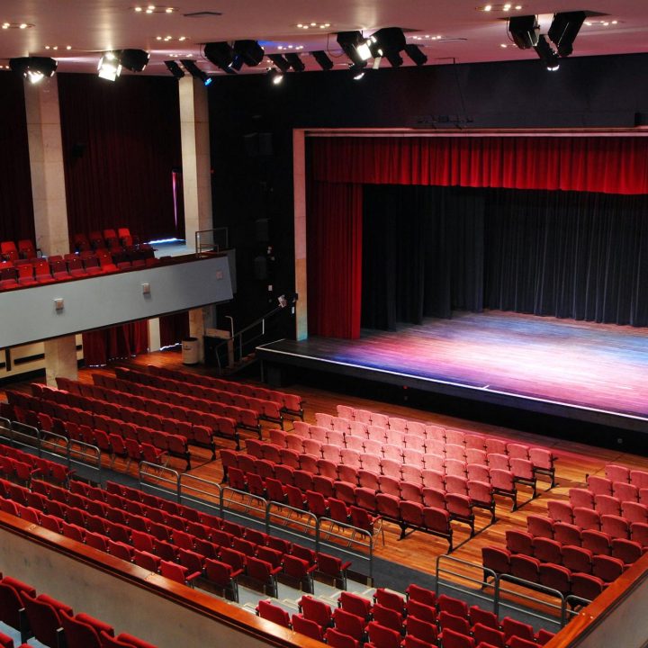 A large Alban Arena theatre with red cushioned seats.