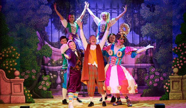 Vibrant stage show at Harpenden's Eric Morecambe Centre with playful costumes and a garden backdrop.