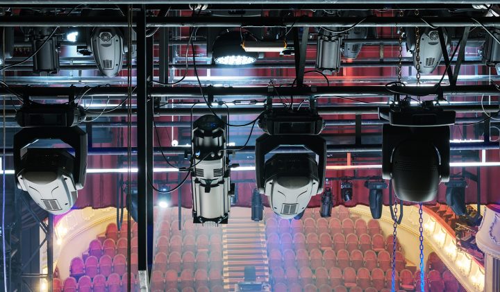 Spotlights illuminate The Alban Arena, highlighting the empty theater seating.